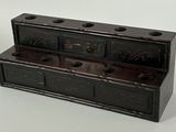 a small wooden box with a clock on it