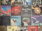many different album covers on the floor of this room
