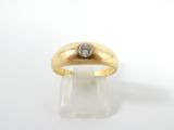 a close up of a gold ring with a diamond on top of it
