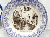 a blue and white plate with a picture on it