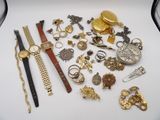 a lot of gold and silver jewelry on a white table