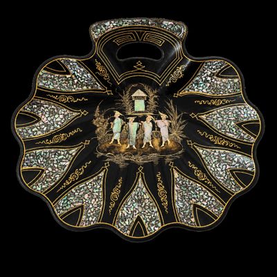 an image of a black and gold plate with a picture on it