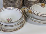 a lot of plates and bowls sitting on a table