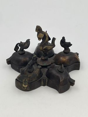 bronze figurine of a boy on a horse with birds on his back