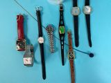 many different types of watches hanging on a wall