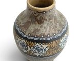 a vase that is sitting on a white surface
