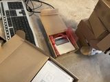 a cardboard box with a keyboard and a computer in it
