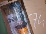 a box with a drill and some other tools inside of it