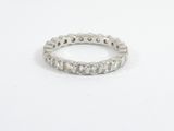a close up of a diamond ring on a white surface