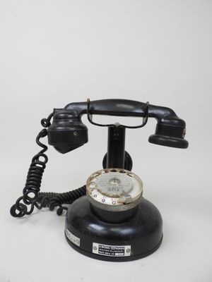 a black telephone that is sitting on a white table