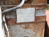 a rusted metal box with a sign on it
