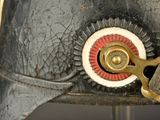 a close up of a metal object with a red and white ring on it