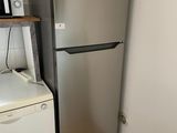 a refrigerator and a washer in a small room