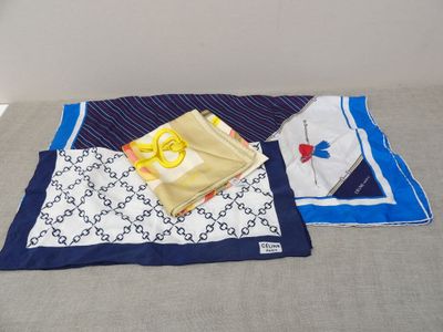a blue and white blanket and a pair of scissors on a bed