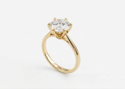 a yellow gold engagement ring with a round brilliant cut diamond
