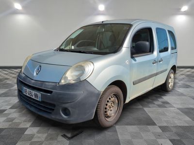 a small blue van parked in a room with checkered floor