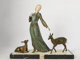 statue of a woman with a deer and a deer on a marble base