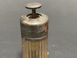 a small glass bottle with a metal top