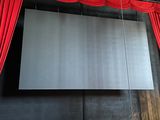 a large screen hanging from the ceiling of a theater