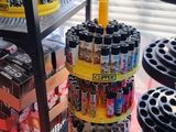 a display of sodas and soda cans in a store