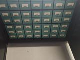 a cabinet with many drawers in it in a room