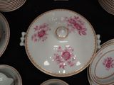 a lot of plates and bowls that are on a table