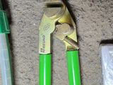a pair of pliers and a pipe cutter on the floor