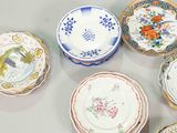 many plates with different designs on them on a table