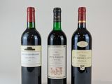 trois bouteilles de vin posées l'une à côté de l'autre sur une table