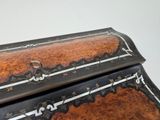 a wooden box with a black and white design on it