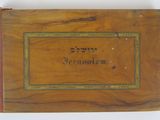 an old wooden box with writing on the front of it
