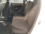 the interior of a car with a seat folded down and a steering wheel