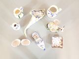many different types of porcelain items on the table