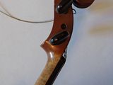 a violin that is sitting on a white surface