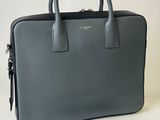 a grey briefcase with a black strap and a black strap