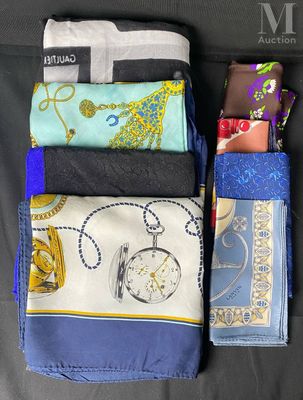 many different types of cloths laid out on a couch