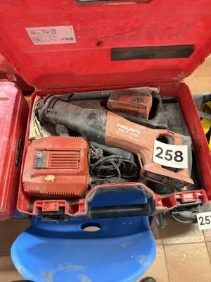 a red tool box with tools in it on the floor
