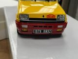 a yellow toy car sitting on top of a white box
