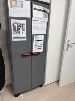 a refrigerator that has a lot of papers on it