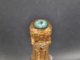 a bottle of champagne with a clock on top of it