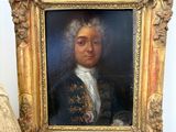 painting of a man in a blue coat with a white collar and a gold frame