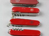 several swiss army knives are lined up on a table