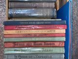 many books stacked on top of each other in a box