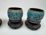 three small vases sitting on top of a table next to each other