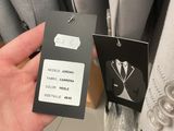 a person holding a tag in their hand in a store