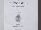 an open book with a picture of a coat of arms on it