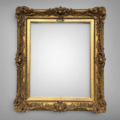 a gold framed mirror with a white background