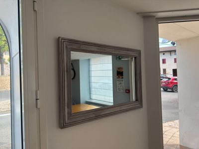 a mirror hanging on the wall in a room