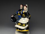figurine of a man and woman riding a motorcycle on a white base