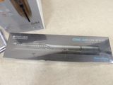 packaging of a hair dryer and comb sitting on a table